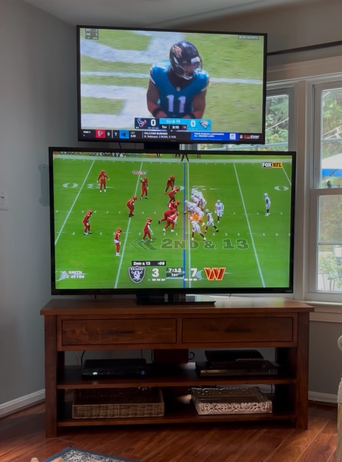 Double TV Stand with two drawers and two open shelves, in a living room