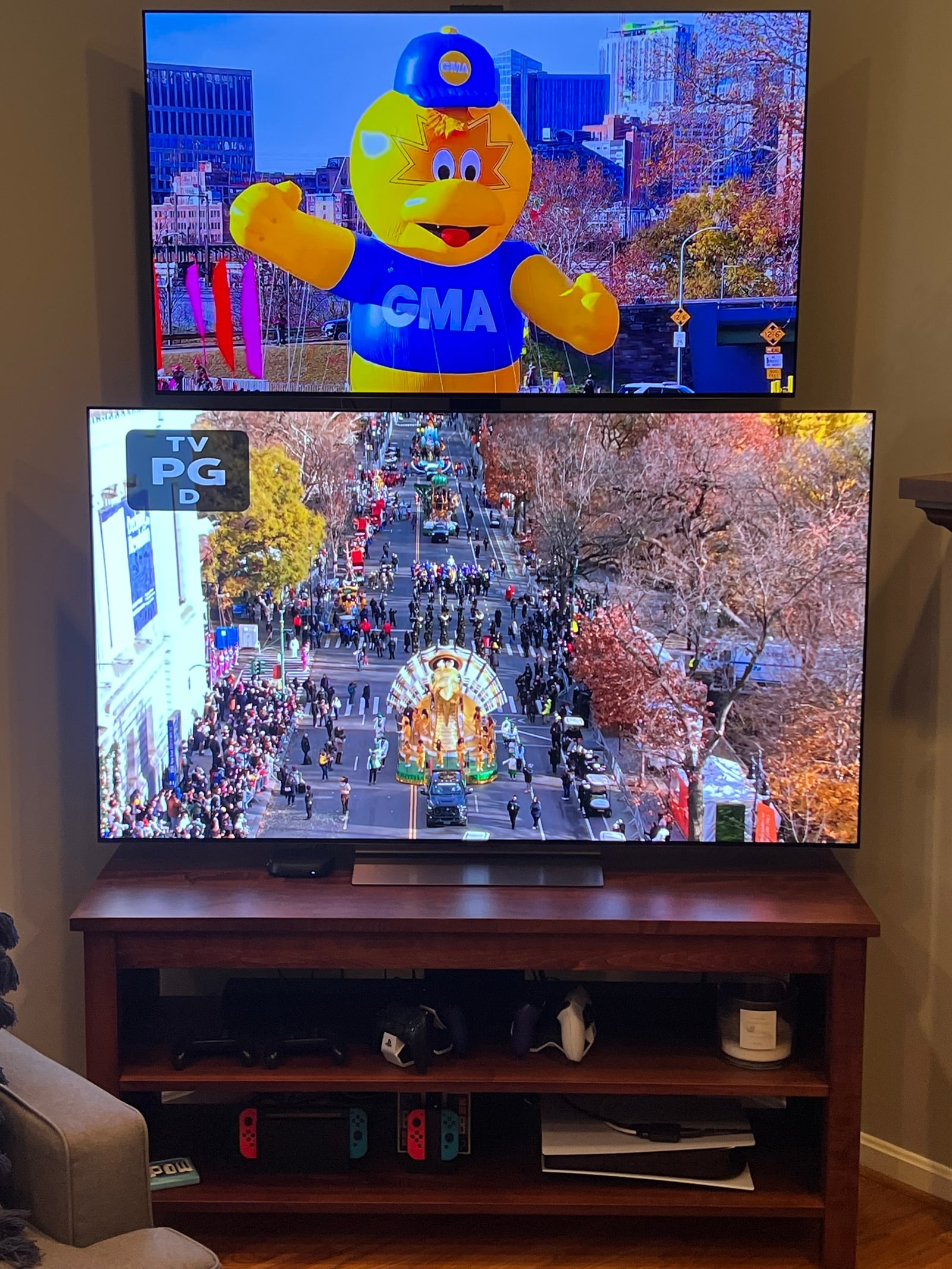 Thanksgiving parade on the raised second TV and on the main screen, in a living room